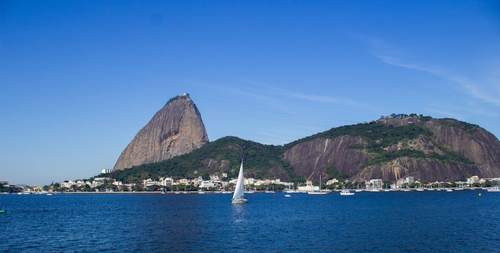 A sailing boat on the bay beneath Sugarloaf Mountain